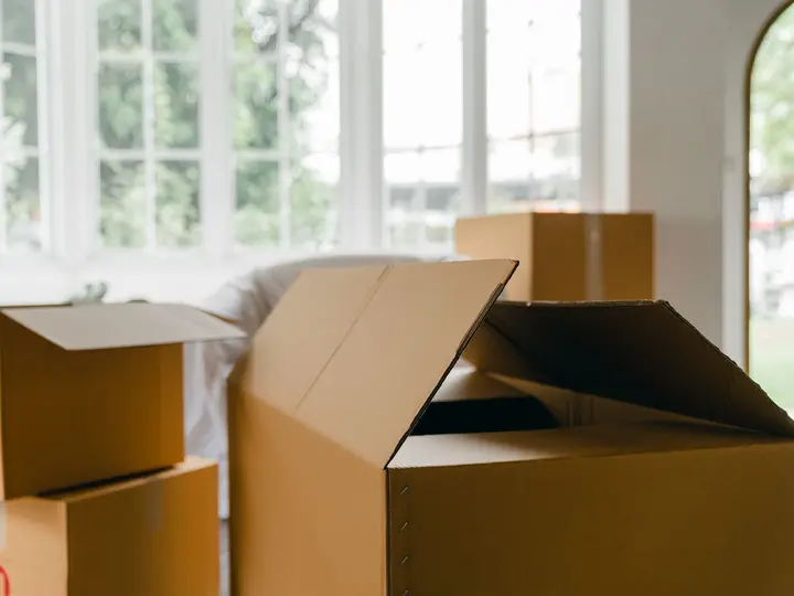 Moving boxes arranged in a bright room